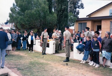Soldiers at gate surrounded by onlookers.