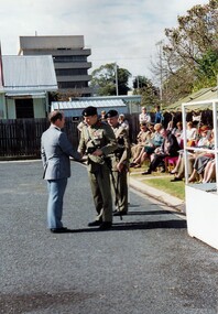 Civilian and soldier shaking hands.