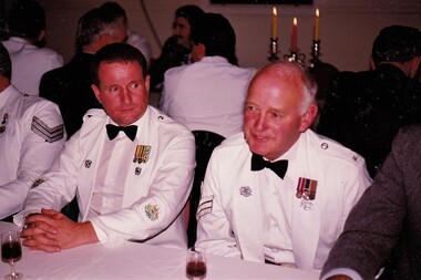 Two soldiers in formal uniform at Dinner.