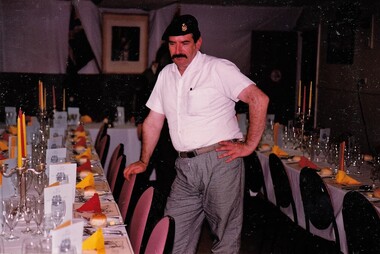 Soldier beside table with place settings, Corporal Tewson