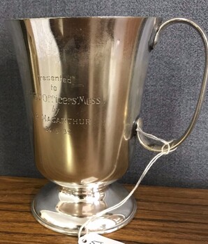 Silver drinking cup with handle and inscription on side. 