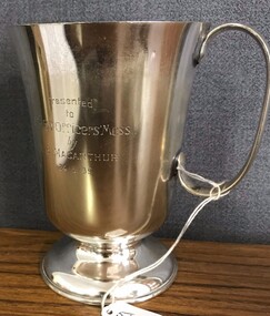 Silver drinking cup with handle and inscription on side. 