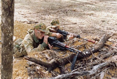 Two soldiers firing from a pit