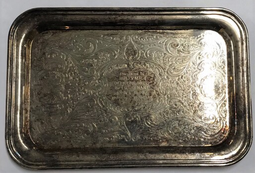 Small flat tray with engraving at centre.