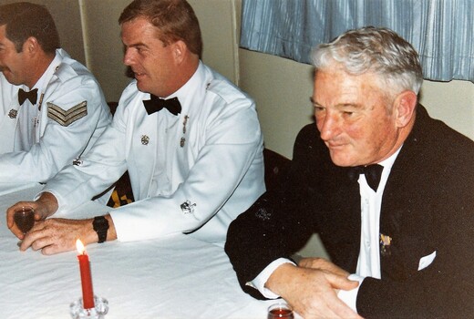 Soldiers and a civcilian in formal dress.