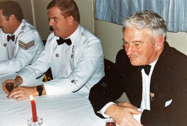 Soldiers and a civcilian in formal dress.