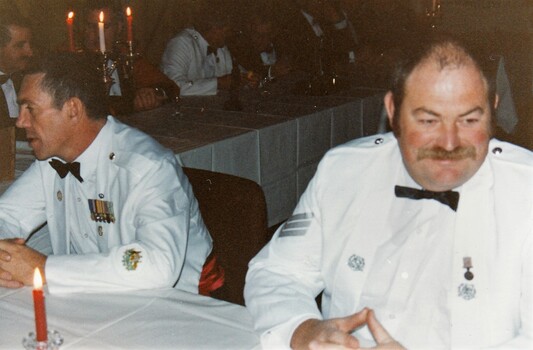 Two soldiers in formal uniforms.