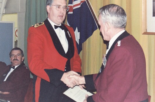 Officers in formal uniform shaking hands