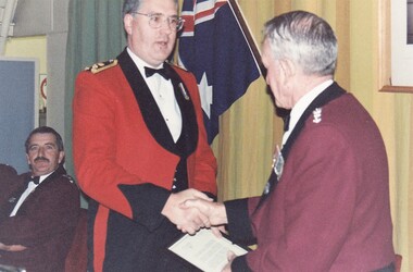 Officers in formal uniform shaking hands