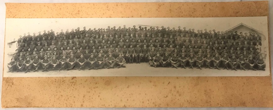 Photograph of large group of soldiers all wearing berets.