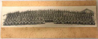 Photograph of large group of soldiers all wearing berets.