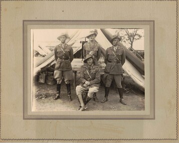 Four army officers outside tent.