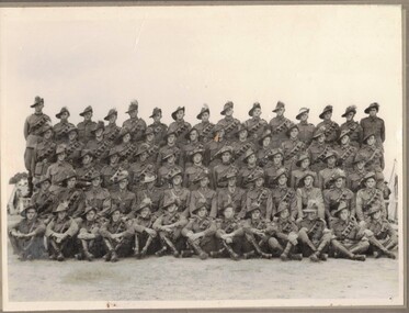 Three rows of soldiers in camp.