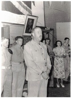 Photograph of aged soldier with group.