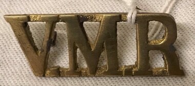 Metal badge of three letters of alphabet