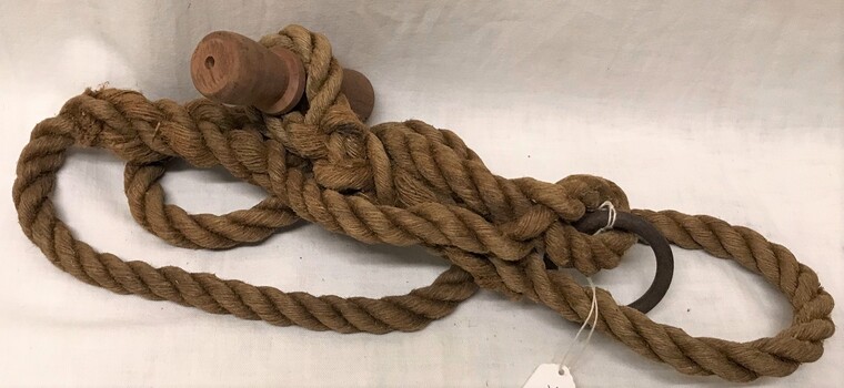 Rope with toggle one end and metal ring other end.