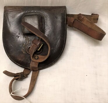 leather wallet with straps, horseshoes inside.