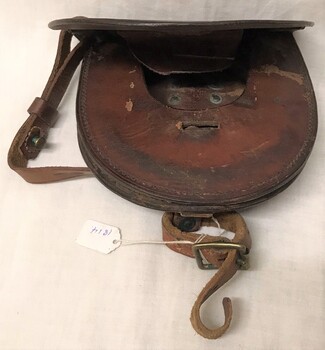 Leather Wallet holding two horse shoes. 