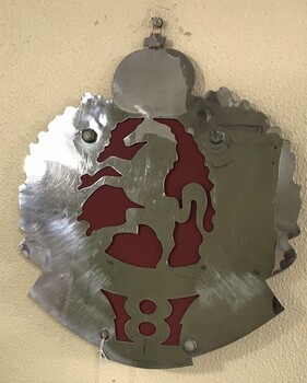 Metal cutout badge with horse image.