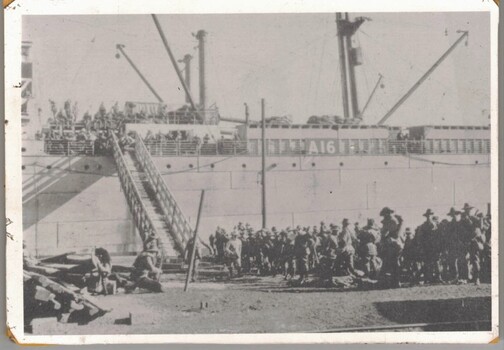 Soldiers on wharf where ship is loading
