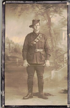 Soldier in uniform holding riding crop