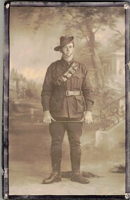 Soldier in uniform holding riding crop
