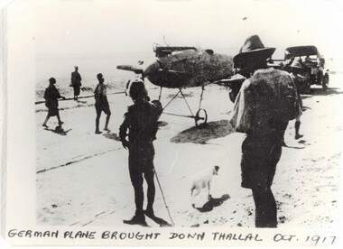 Soldiers near very old aircraft in desert