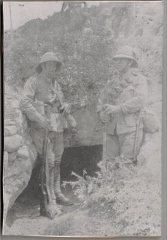 Two soldiers standing in trench.