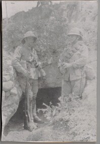 Two soldiers standing in trench.