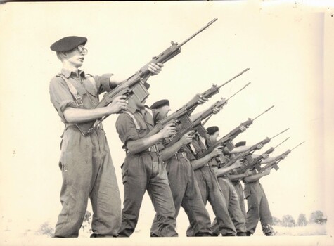 Six soldiers training with rifles.