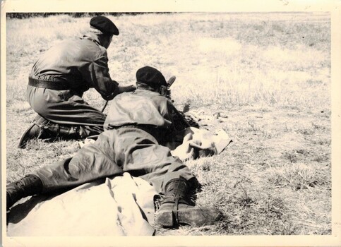 Two soldiers firing machine gun