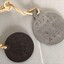 Two small metal objects connected by string