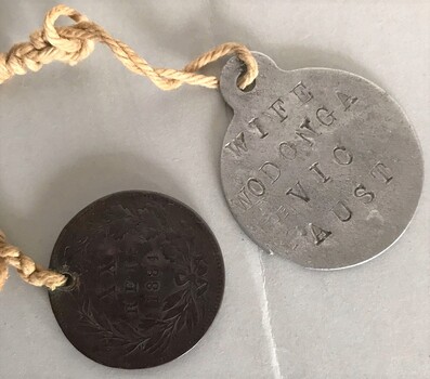 Two small metal objects connected by string