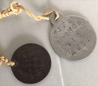 Two small metal objects connected by string