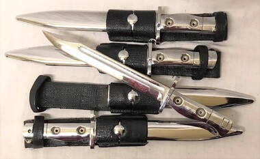 Four shiny bayonets with scabbards 