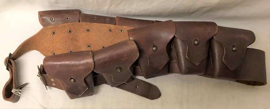 Leather sash with small pouches attached.