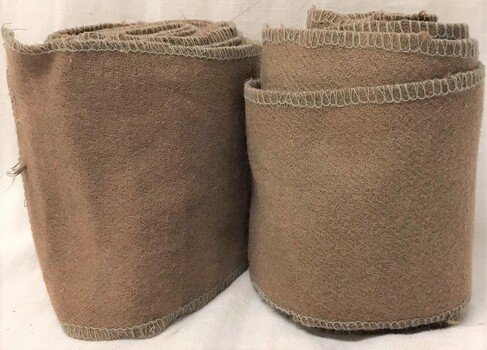 Two rolls of fabric with hemmed edges.