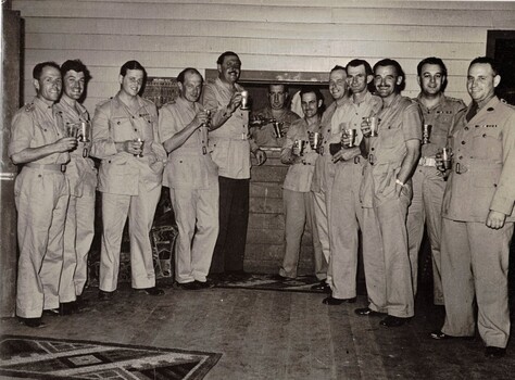 Group of soldiers holding drinking tankards.