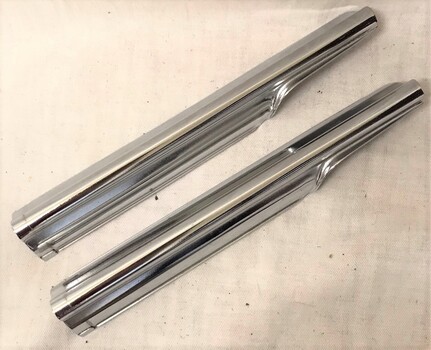 Two shiny curved metal covers 