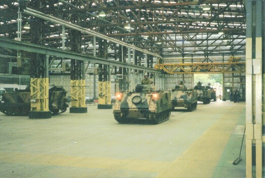 Tracked army vehicles in big shed