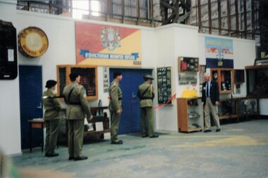 Soldiers standing in a museum with signs.