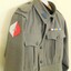 Khaki jacket with colour patch on sleeve.