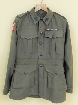 Khaki jacket with metal buttons and badges.