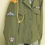 Army jacket with coloured badges on sleeve.
