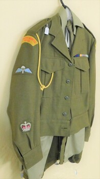 Army jacket with coloured badges on sleeve.