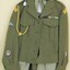 Khaki uniform with badges on jacket.