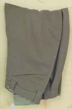 Khaki trousers with tapered legs.