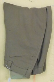 Khaki trousers with tapered legs.