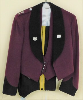 Formal uniform with badges, yellow stripes on trousers.