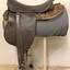 Leather riding saddle placed on a metal stand